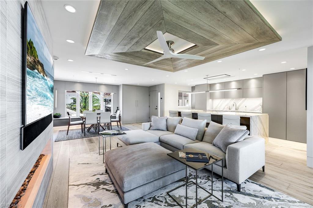 295 5th Avenue South Naples, FL 34102 - Photo 2 of 29 a living room with furniture and a flat screen tv