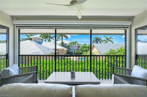 a balcony with furniture and a potted plant