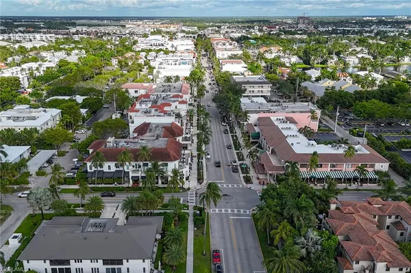 an aerial view of residential houses with outdoor space and swimming pool