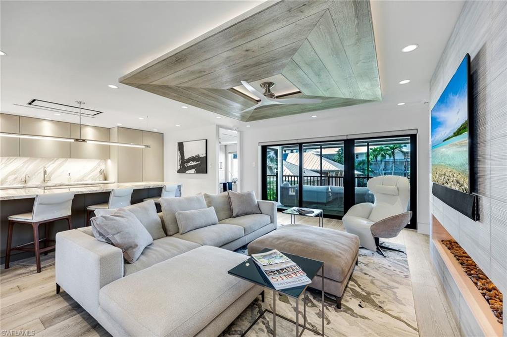 295 5th Avenue South Naples, FL 34102 - Photo 4 of 29 a living room with furniture large window and wooden floor
