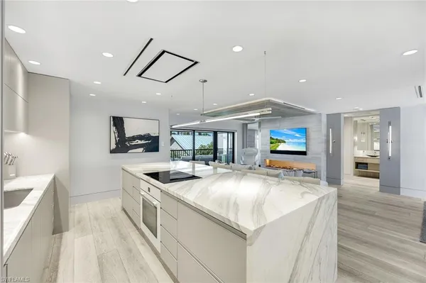 a kitchen with stainless steel appliances granite countertop a sink and a stove