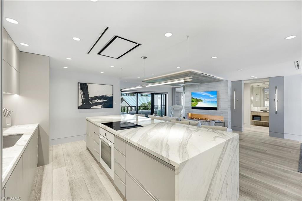 295 5th Avenue South Naples, FL 34102 - Photo 8 of 29 a kitchen with stainless steel appliances granite countertop a sink and a stove