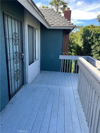 a view of backyard with a deck and wooden floor