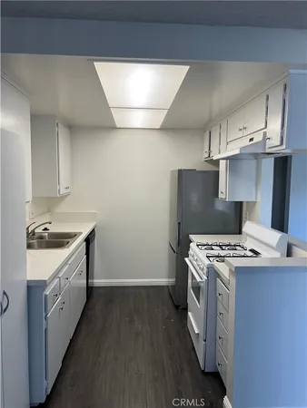 a kitchen with a stove top oven sink and cabinets