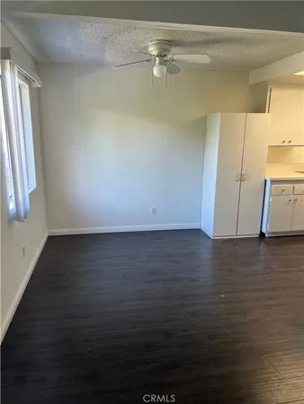 a view of a room with wooden floor and a window