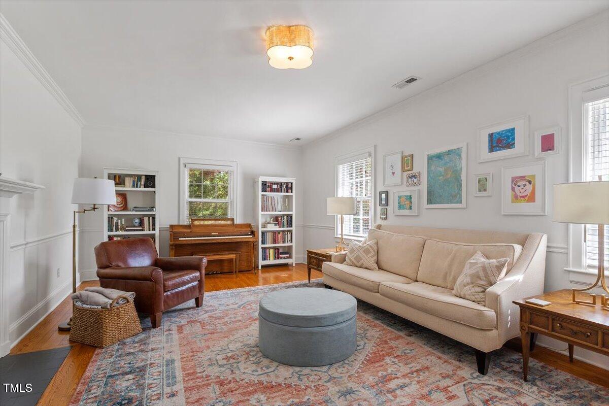 5212 Theys Road Raleigh, NC 27606 - Photo 10 of 56 a living room with furniture and a flat screen tv