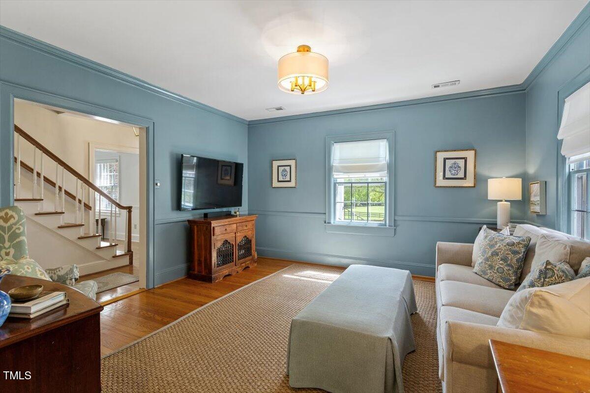 5212 Theys Road Raleigh, NC 27606 - Photo 12 of 56 a bedroom with furniture and a flat screen tv