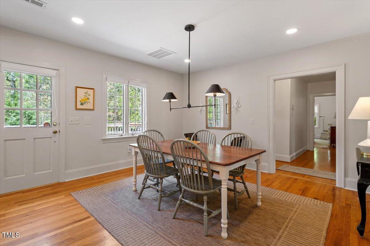 5212 Theys Road Raleigh, NC 27606 - Photo 15 of 56 a view of a dining room with furniture window and wooden floor
