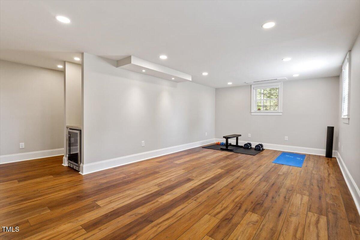 5212 Theys Road Raleigh, NC 27606 - Photo 23 of 56 a view of a room with gym equipment and wooden floor