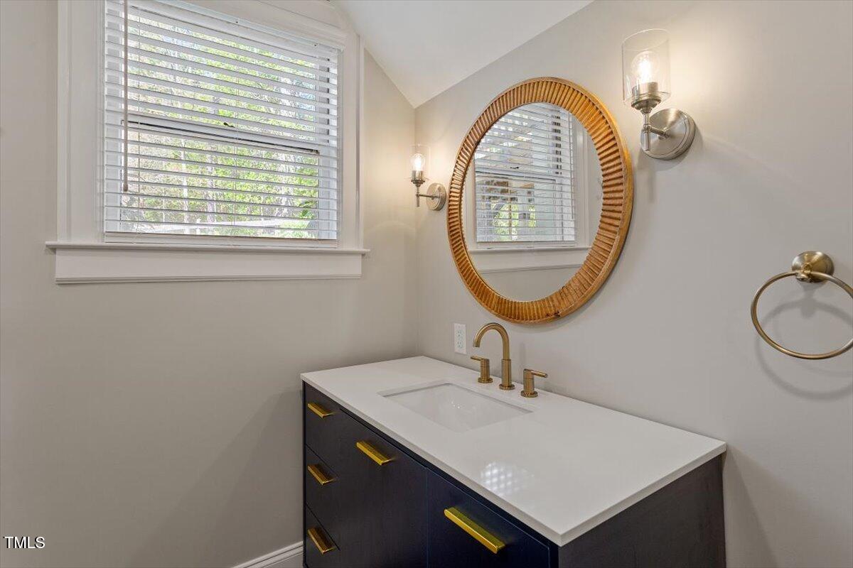 5212 Theys Road Raleigh, NC 27606 - Photo 24 of 56 a bathroom with a sink and a mirror