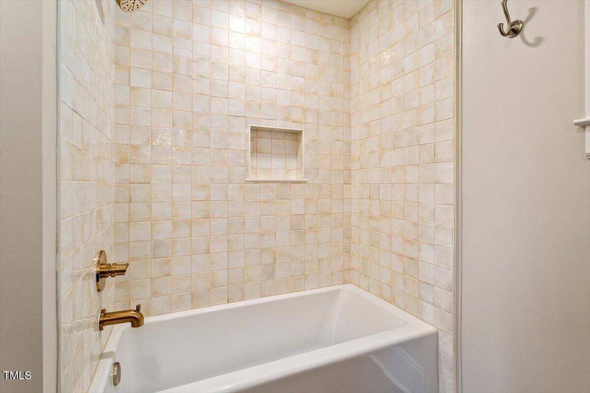5212 Theys Road Raleigh, NC 27606 - Photo 25 of 56 a bathroom with a bathtub