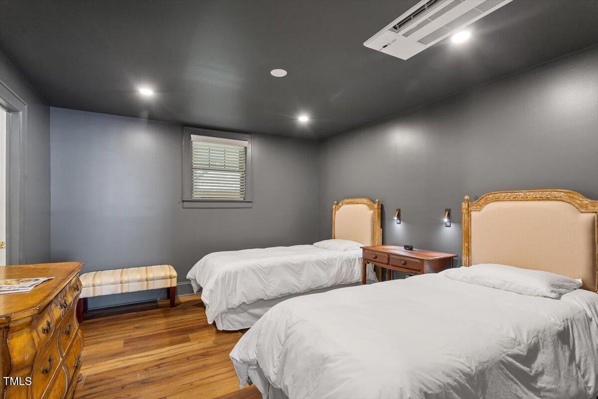 5212 Theys Road Raleigh, NC 27606 - Photo 32 of 56 a bedroom with two beds and wooden floor