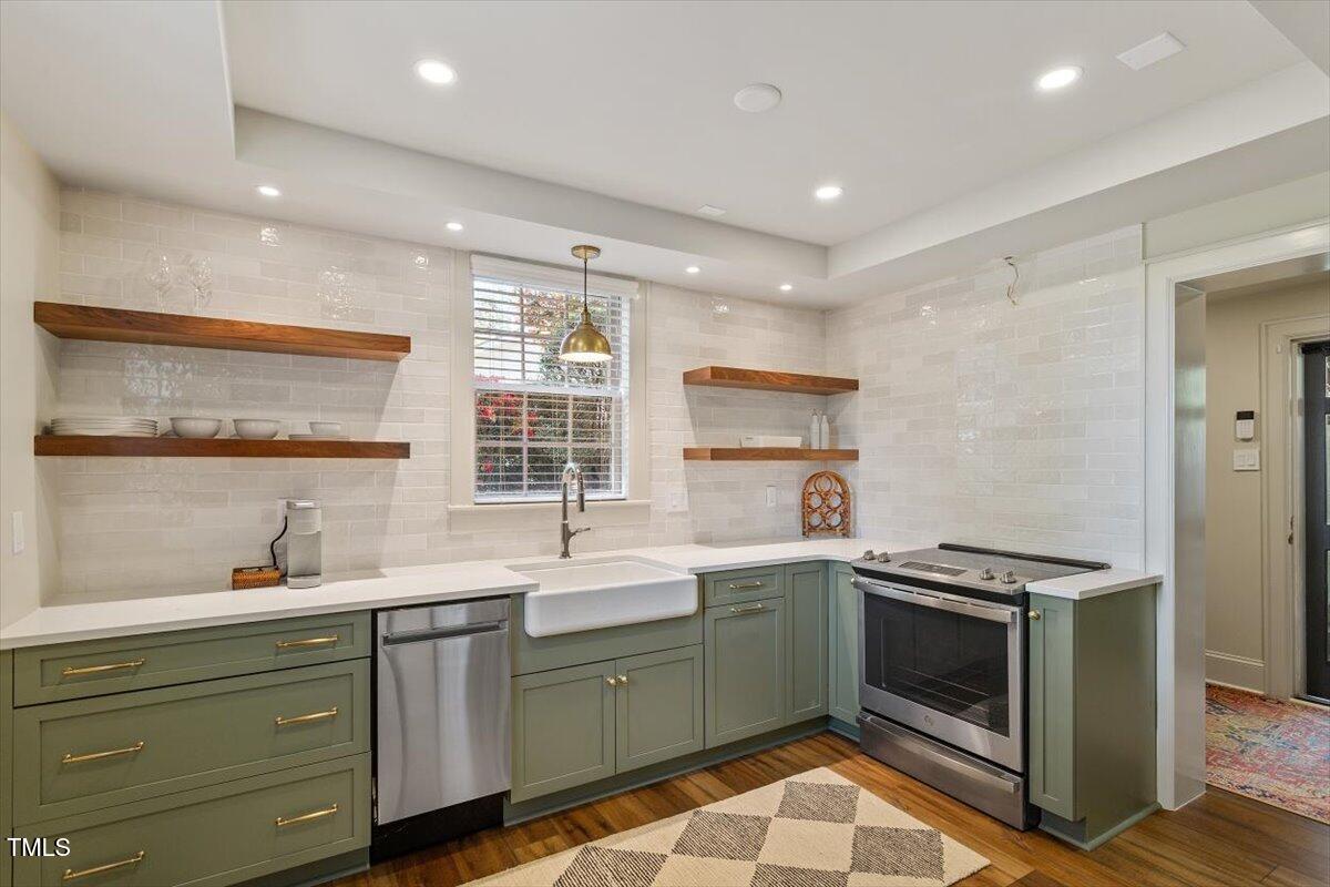 5212 Theys Road Raleigh, NC 27606 - Photo 34 of 56 a kitchen with a sink stove and cabinets