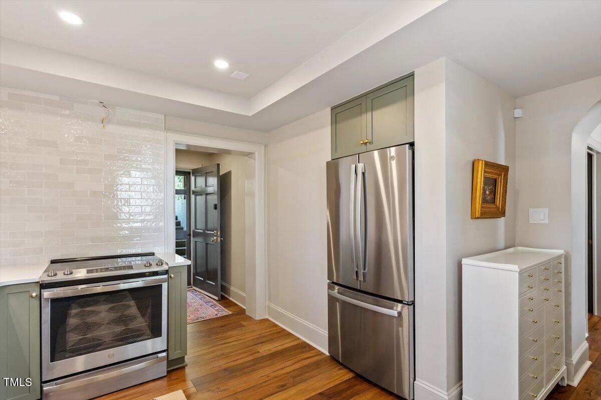 5212 Theys Road Raleigh, NC 27606 - Photo 35 of 56 a metallic refrigerator freezer sitting in a kitchen