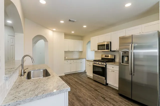 an empty room with a view of a livingroom with a window