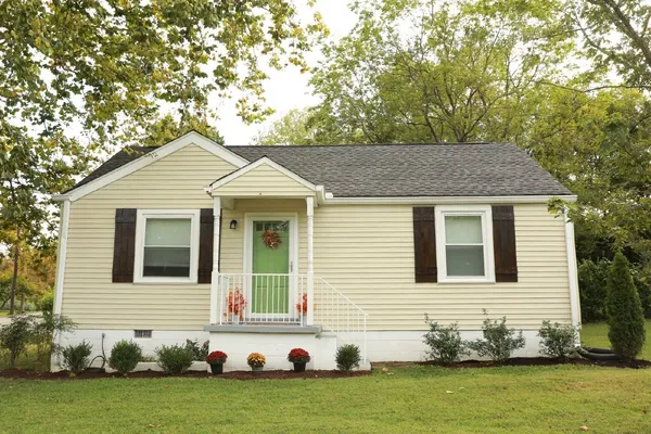 a front view of a house with a garden