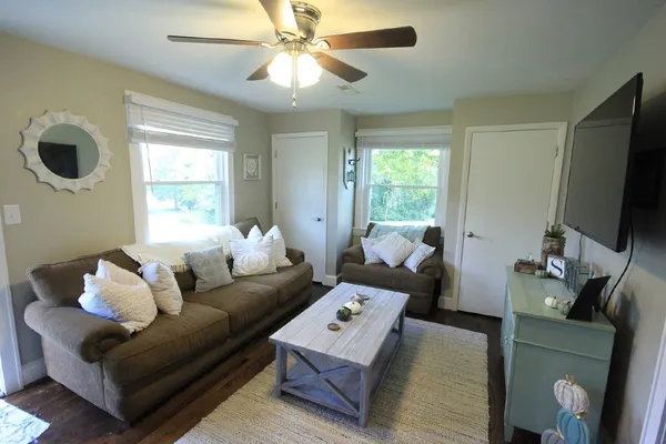 a living room with furniture and a flat screen tv
