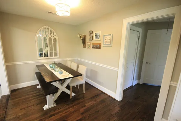 a view of a hallway with wooden floor and windows