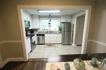 a kitchen with stainless steel appliances granite countertop a refrigerator and a stove top oven