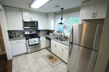 a kitchen with stainless steel appliances a refrigerator sink and microwave