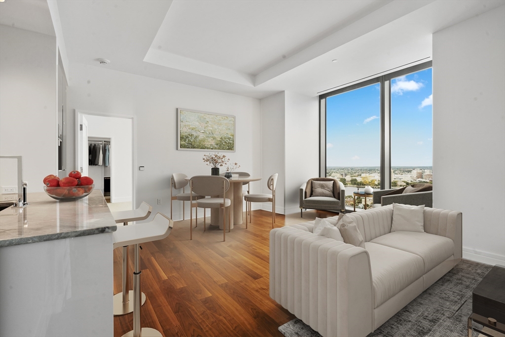 a living room with furniture potted plant and a large window