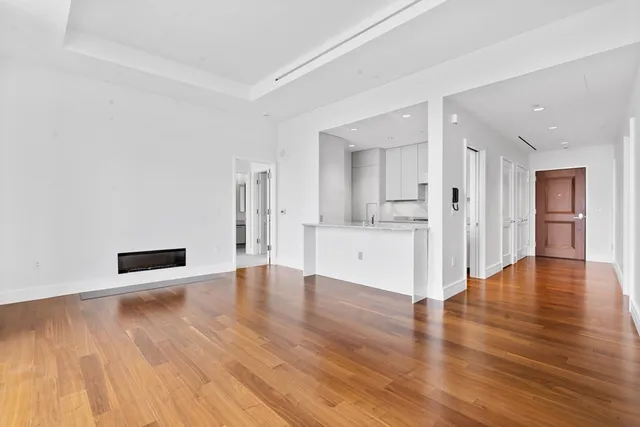a view of a kitchen with wooden floor and a kitchen