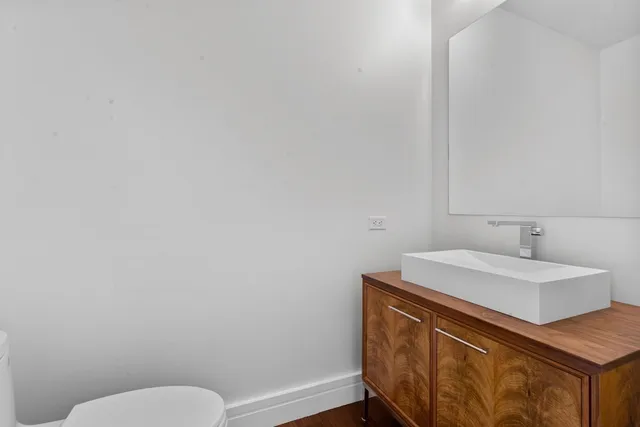 a bathroom with a sink toilet and vanity