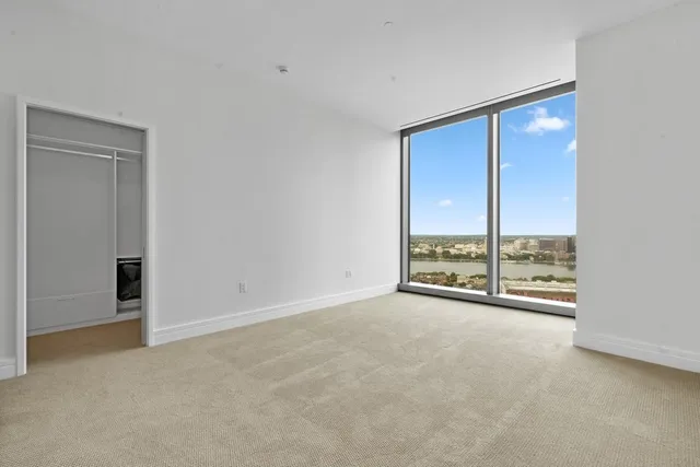 an empty room with large windows