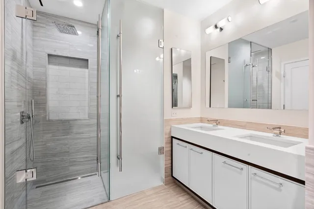 a bathroom with a shower sink and mirror