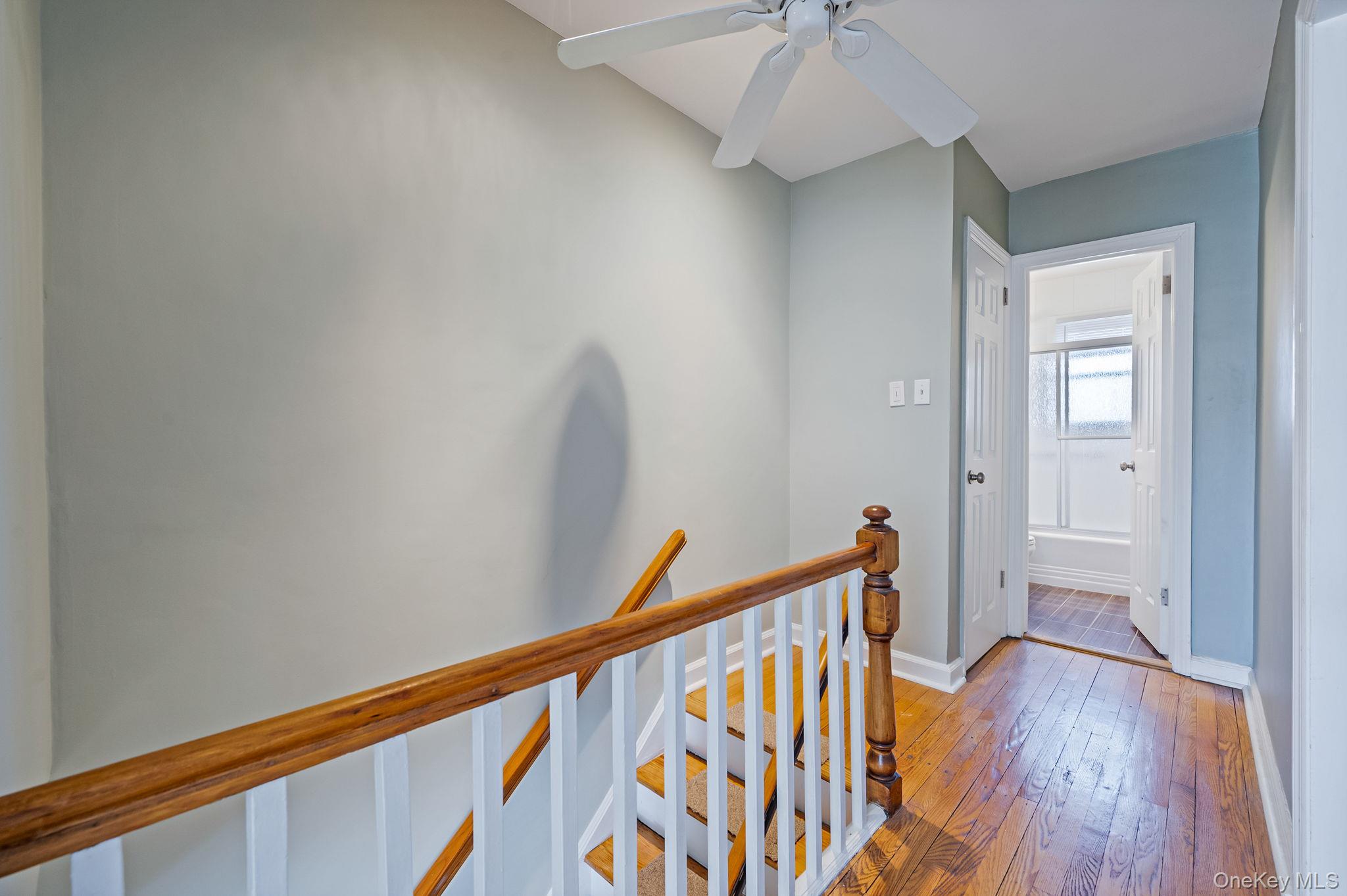 148-07 61st Road Queens, NY 11367 - Photo 11 of 21 Hallway featuring an upstairs landing and light wood-style flooring