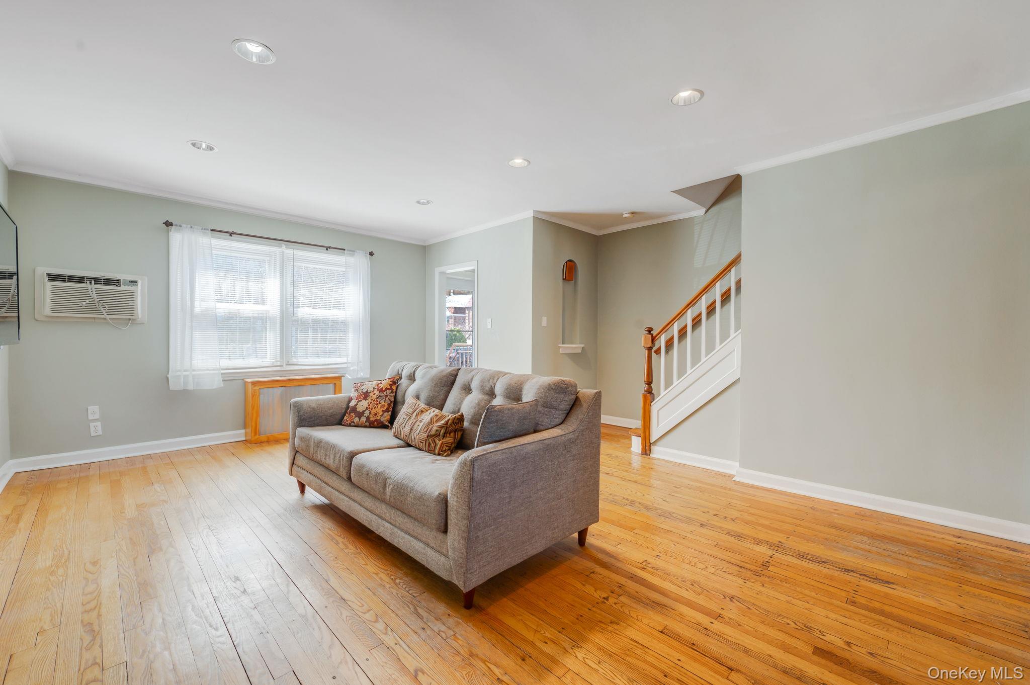 148-07 61st Road Queens, NY 11367 - Photo 6 of 21 Living room featuring light wood-style flooring, crown molding, and recessed lighting
