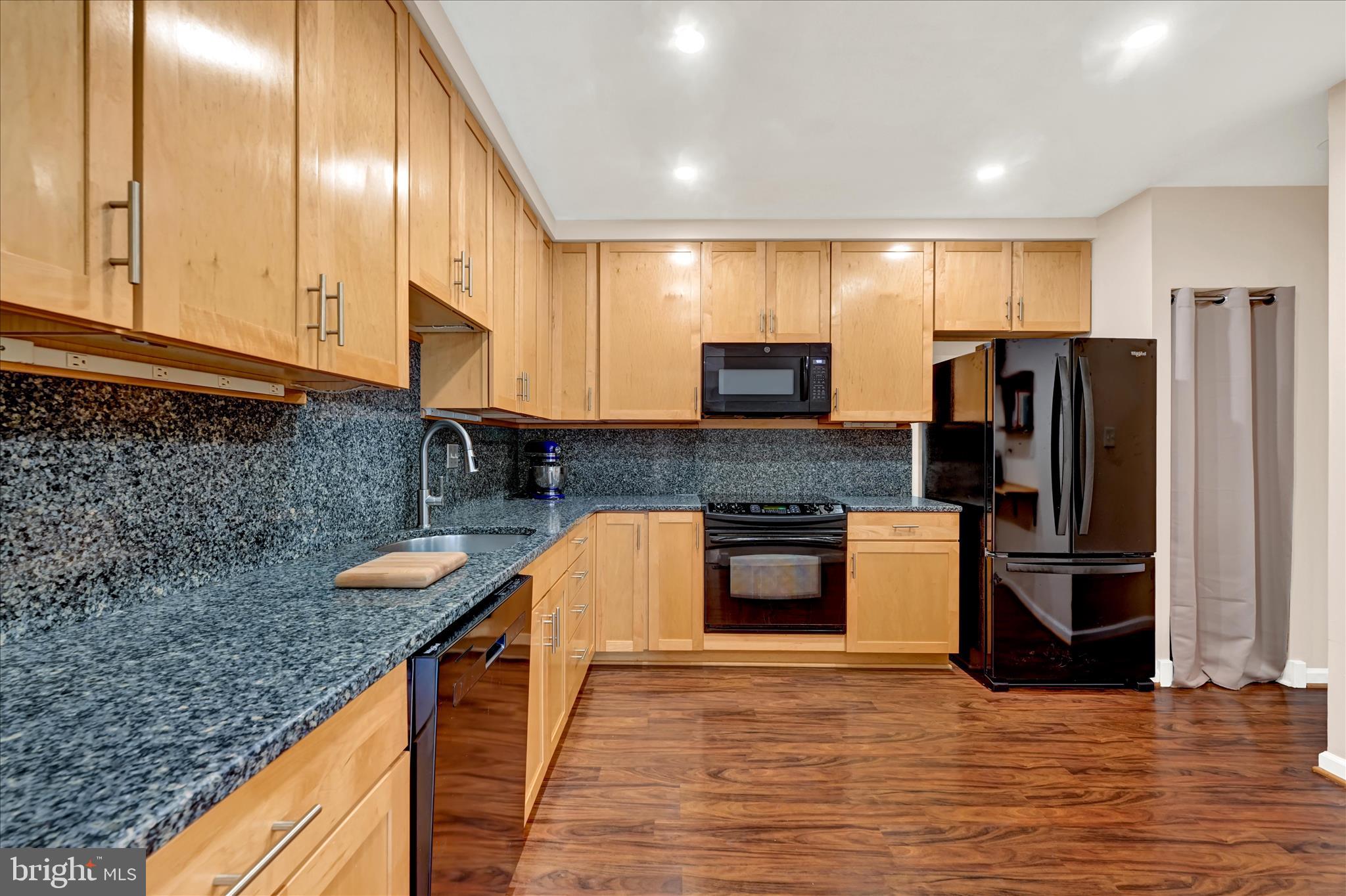 2317 Wonderview Road Lutherville-Timonium, MD 21093 - Photo 8 of 27 a kitchen with stainless steel appliances granite countertop a refrigerator a stove and a sink
