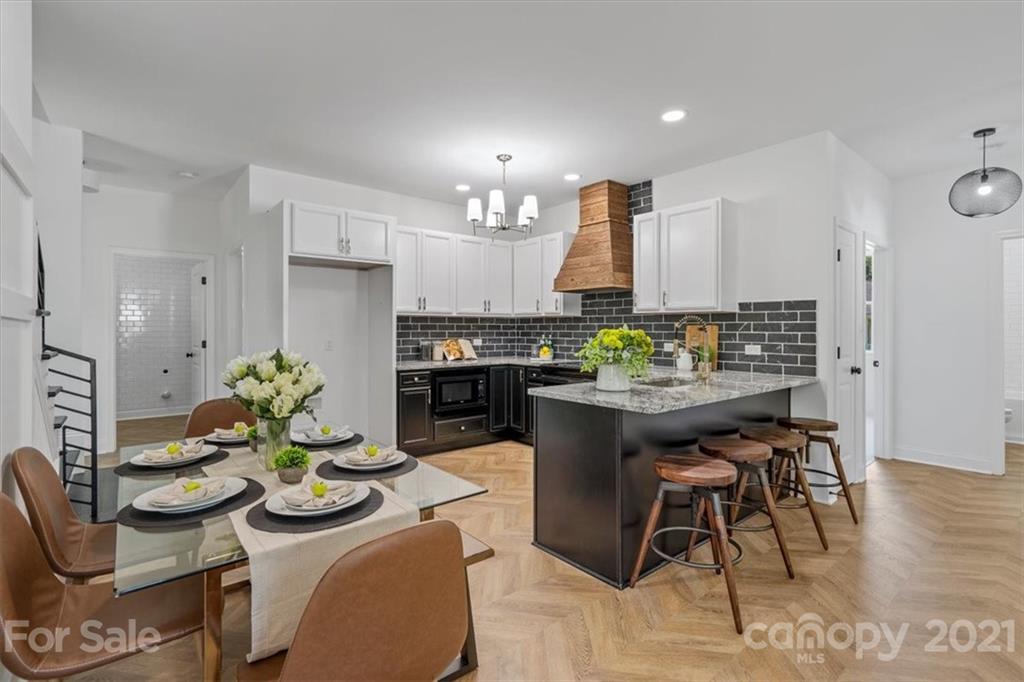 1902 Dunlap Roddey Road Rock Hill, SC 29730 - Photo 11 of 37 a kitchen with stainless steel appliances kitchen island granite countertop a table and chairs