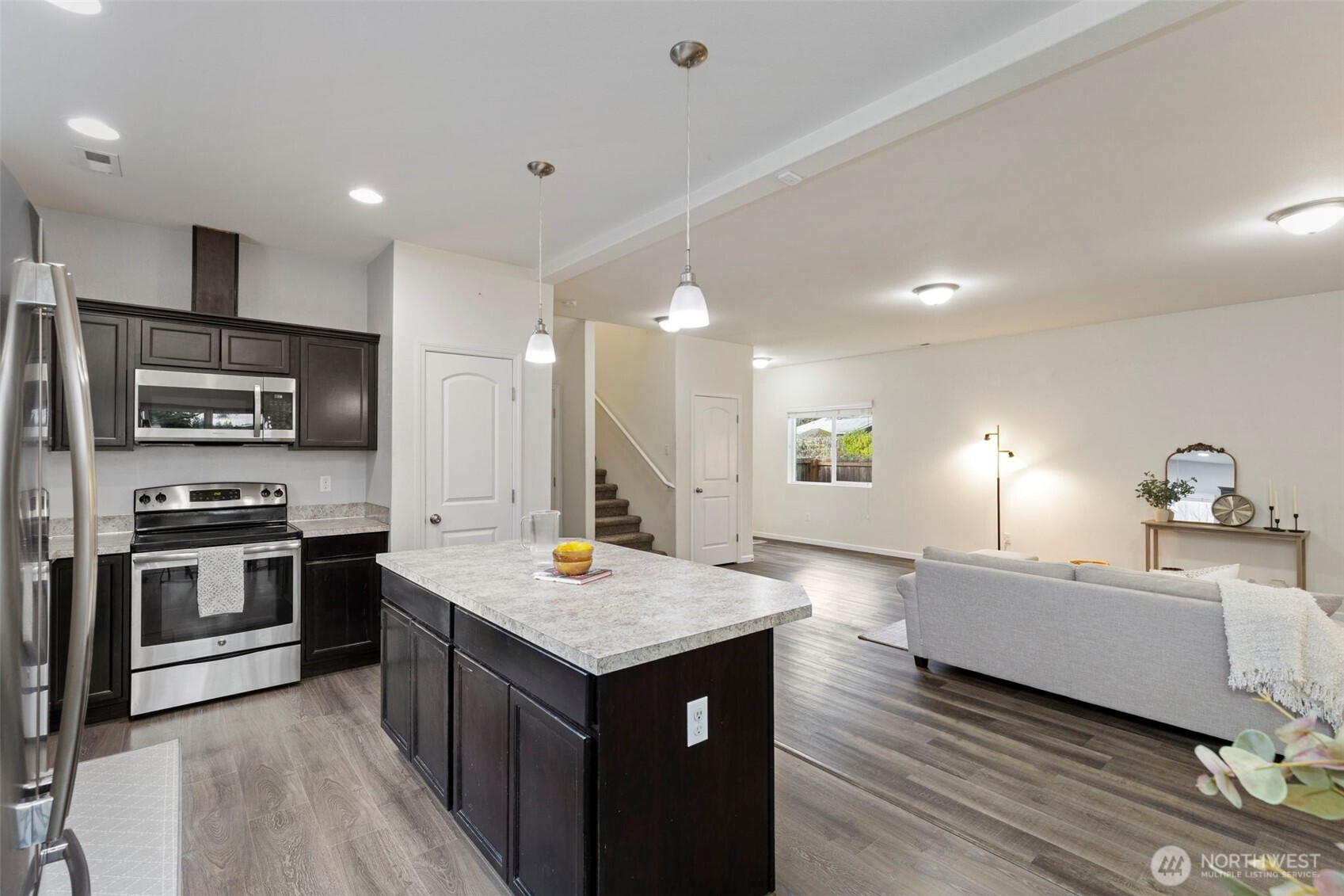 141 Southwest Marcia Way Port Orchard, WA 98366 - Photo 7 of 21 a open kitchen with stainless steel appliances granite countertop a sink dishwasher stove and refrigerator with wooden floor