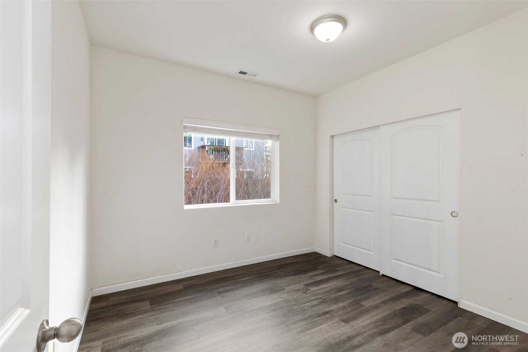 141 Southwest Marcia Way Port Orchard, WA 98366 - Photo 9 of 21 an empty room with wooden floor and windows