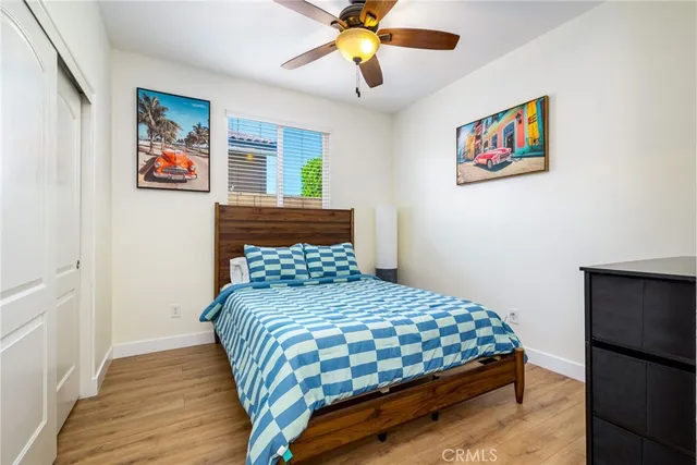 a bedroom with a bed and a painting on the wall