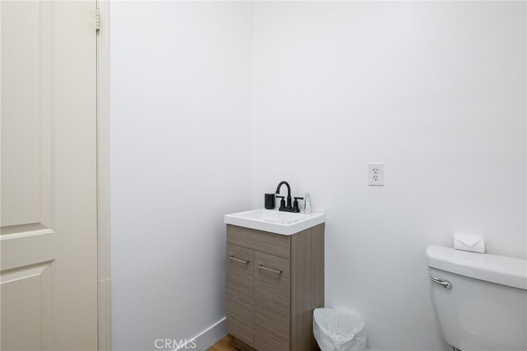 84290 Tramonto Way Indio, CA 92203 - Photo 29 of 45 a bathroom with a toilet a sink and mirror