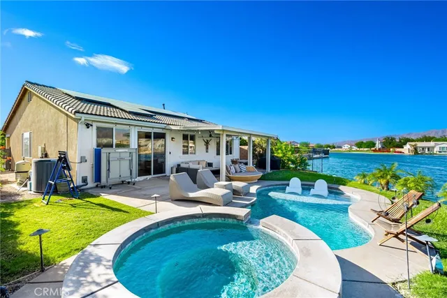 a view of a house with swimming pool and porch with furniture