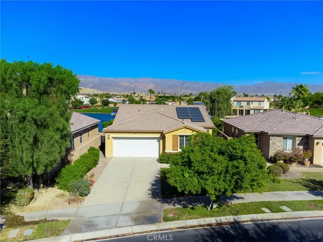 a aerial view of a house with a yard and lake view