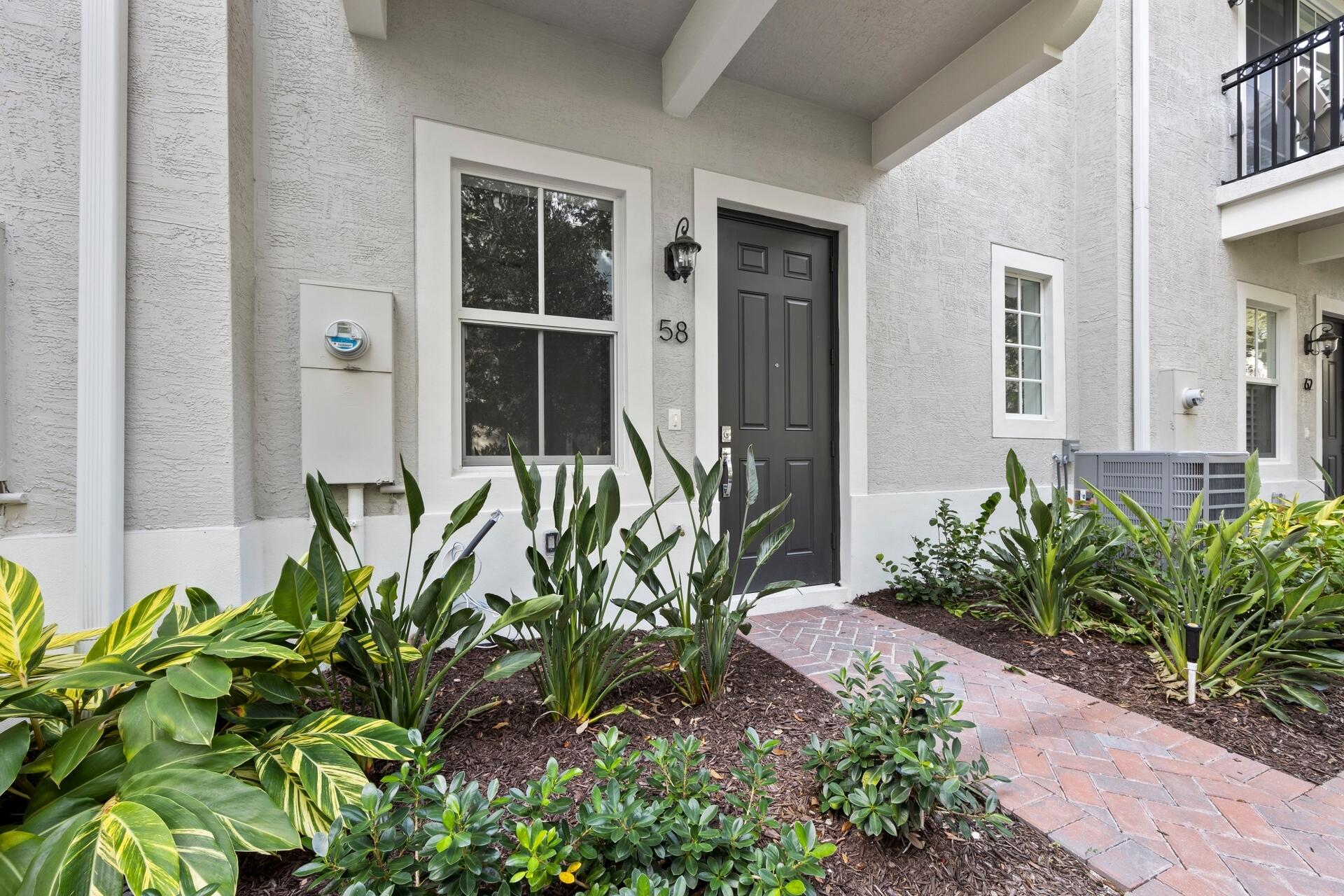 58 Atlantic Grove Way Delray Beach, FL 33444 - Photo 2 of 19 a plant is in front of a house