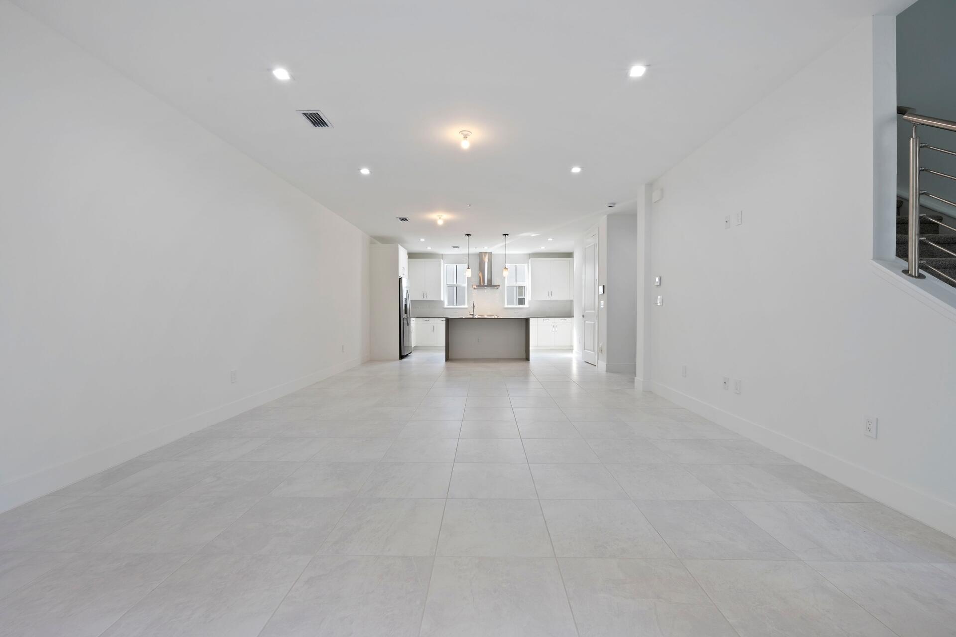 58 Atlantic Grove Way Delray Beach, FL 33444 - Photo 5 of 19 a view of a kitchen with a sink and a refrigerator