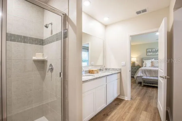 a bathroom with a granite countertop sink and a mirror