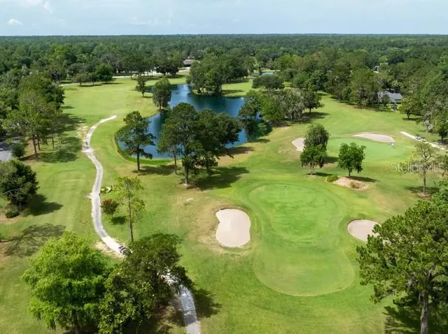 a backyard of a house with lots of green space and fountain
