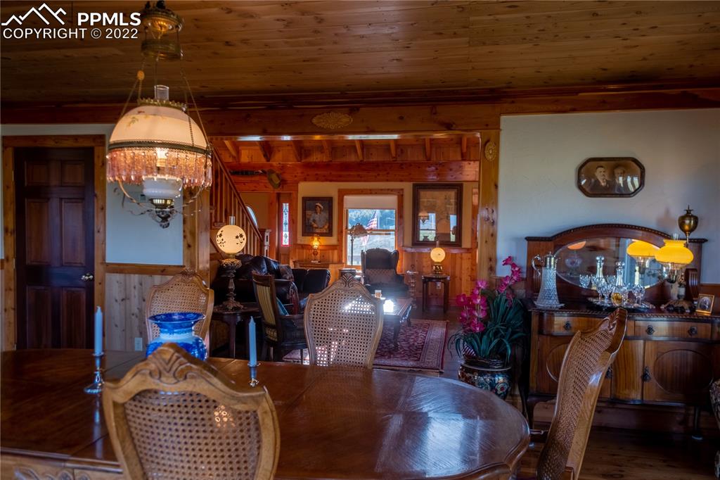 85 Excelsior Road Silver Cliff, CO 81252 - Photo 14 of 27 a view of a dining room with furniture and chandelier