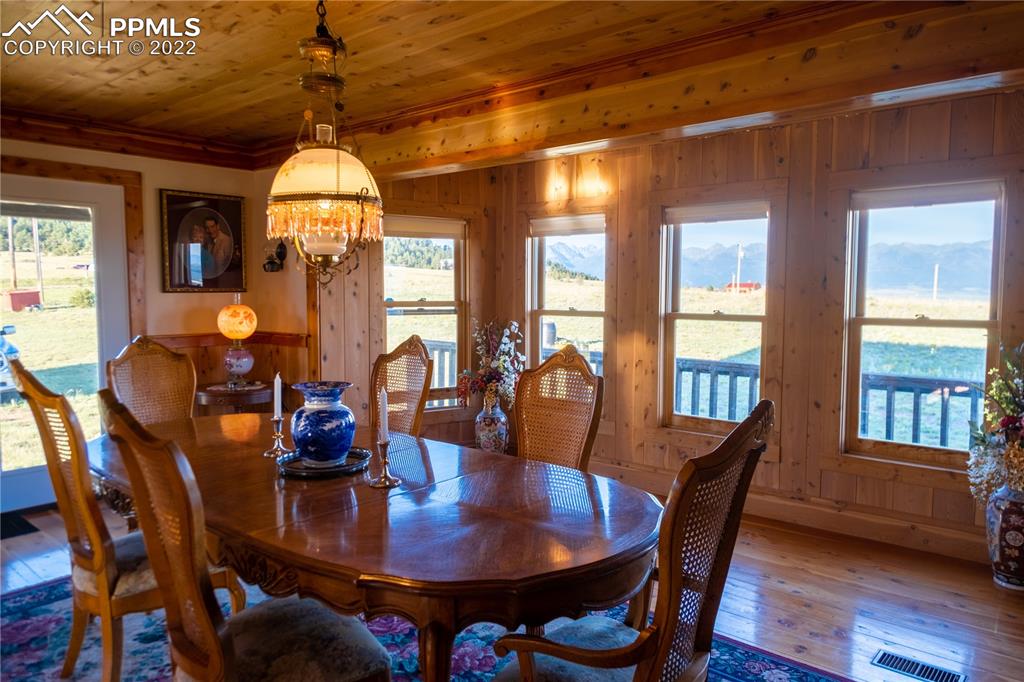 85 Excelsior Road Silver Cliff, CO 81252 - Photo 16 of 27 a view of a dining room with furniture window and wooden floor