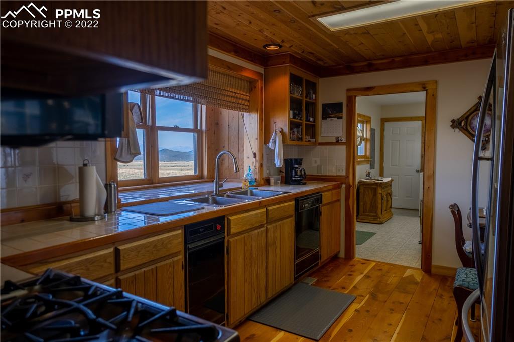 85 Excelsior Road Silver Cliff, CO 81252 - Photo 17 of 27 a kitchen with lots of counter top space and stainless steel appliances