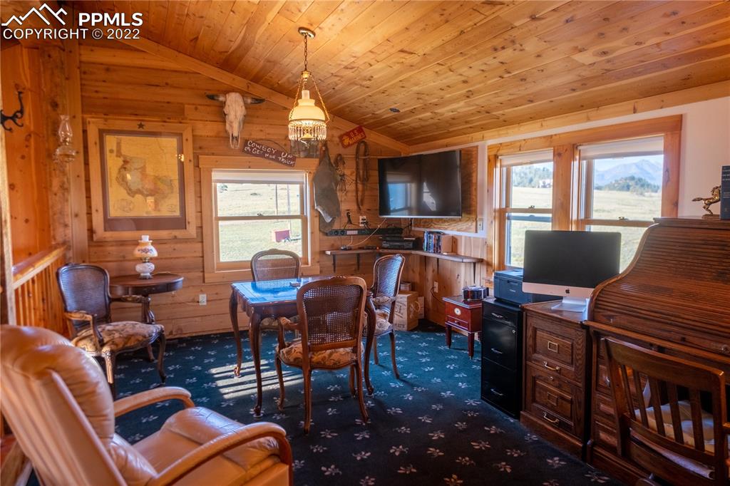 85 Excelsior Road Silver Cliff, CO 81252 - Photo 22 of 27 a work room with furniture a large window and wooden floor