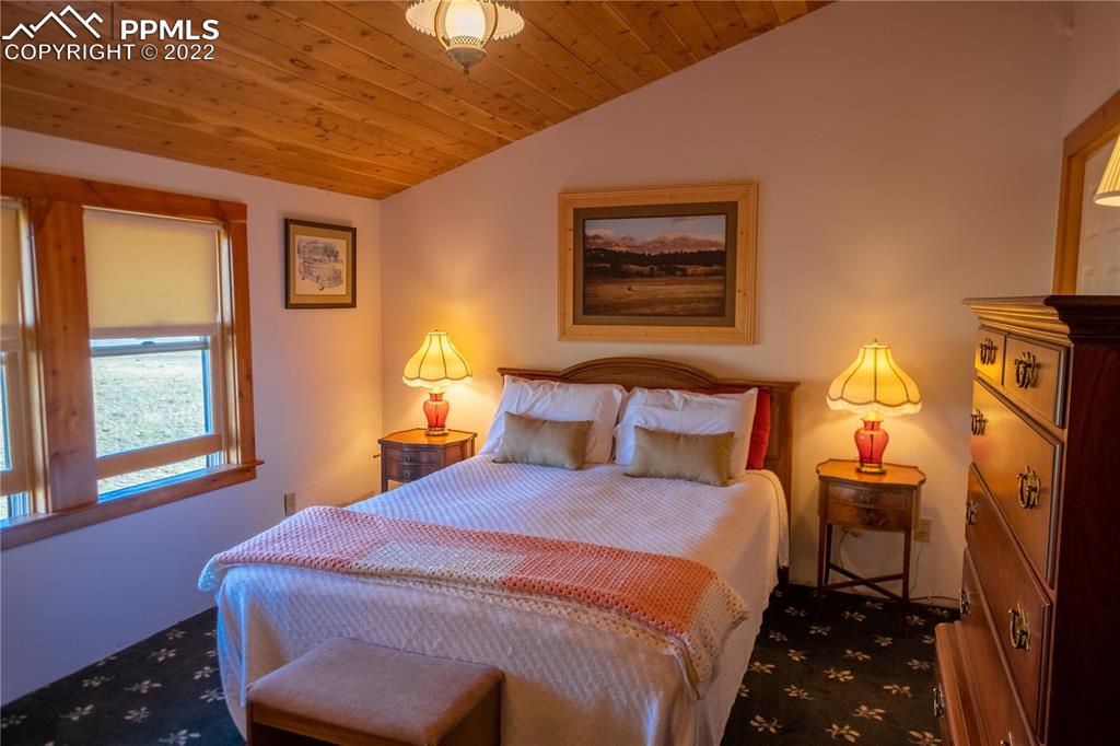 85 Excelsior Road Silver Cliff, CO 81252 - Photo 24 of 27 a bedroom with a bed and a window