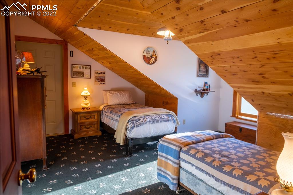 85 Excelsior Road Silver Cliff, CO 81252 - Photo 25 of 27 a bedroom with bed and wooden floor