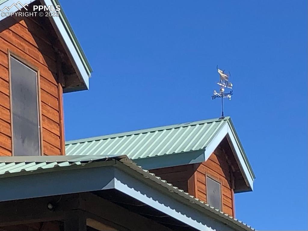 85 Excelsior Road Silver Cliff, CO 81252 - Photo 27 of 27 a roof deck with a chair and table